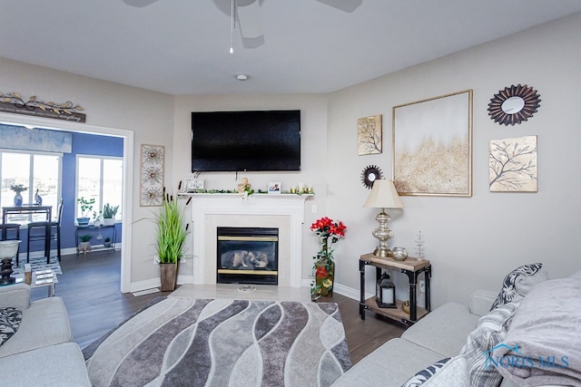 living room with dark hardwood / wood-style floors and ceiling fan