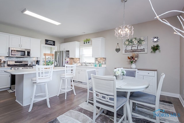 kitchen with stainless steel appliances, a center island, and white cabinetry