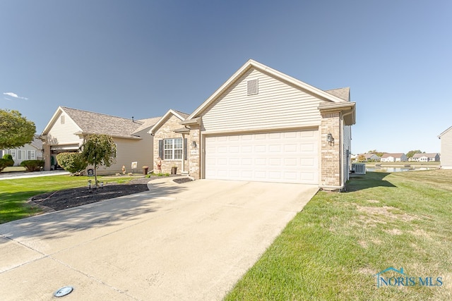 ranch-style house featuring a garage, central AC, and a front lawn