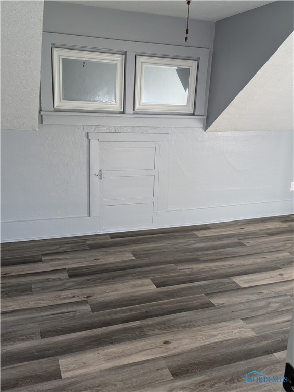 unfurnished room with dark hardwood / wood-style floors