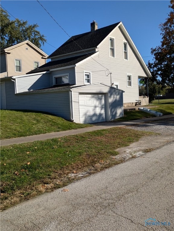 view of property exterior with a garage and a yard