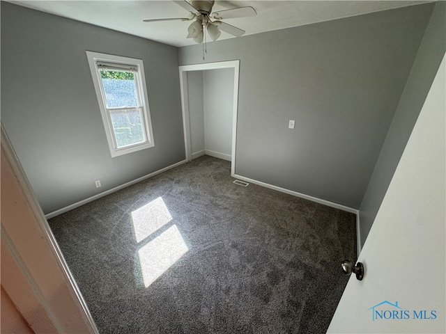 unfurnished bedroom featuring ceiling fan and carpet flooring