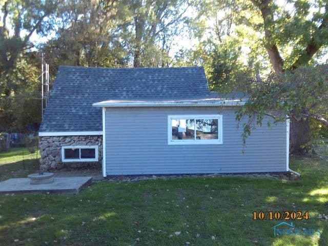 view of home's exterior with a yard