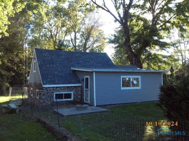 back of property featuring a lawn and a patio area