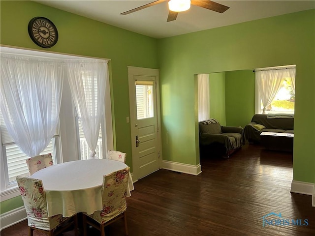 dining room with ceiling fan, dark wood-type flooring, and a wealth of natural light