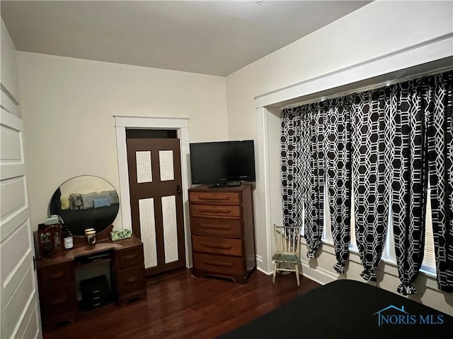 bedroom featuring dark wood-type flooring