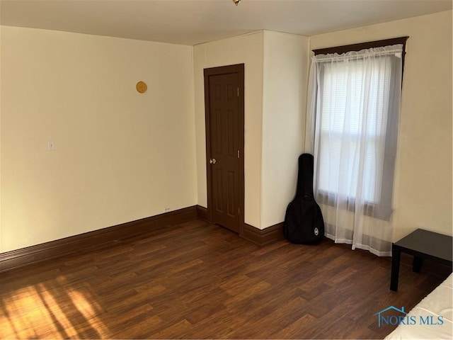 spare room featuring dark hardwood / wood-style floors