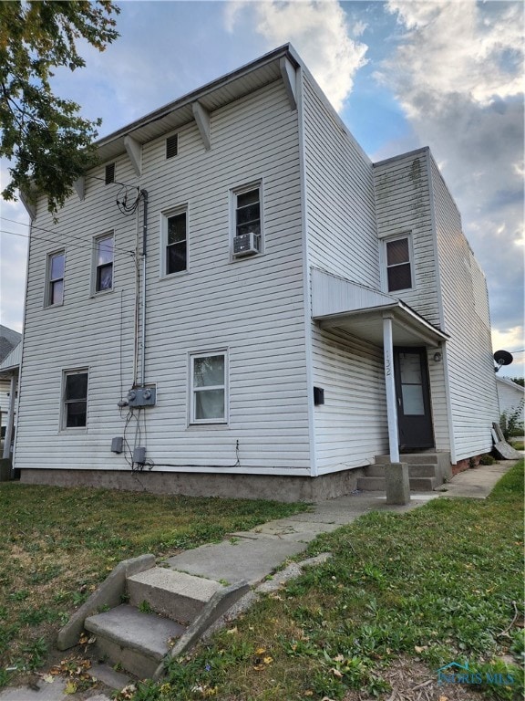 view of side of property with a yard