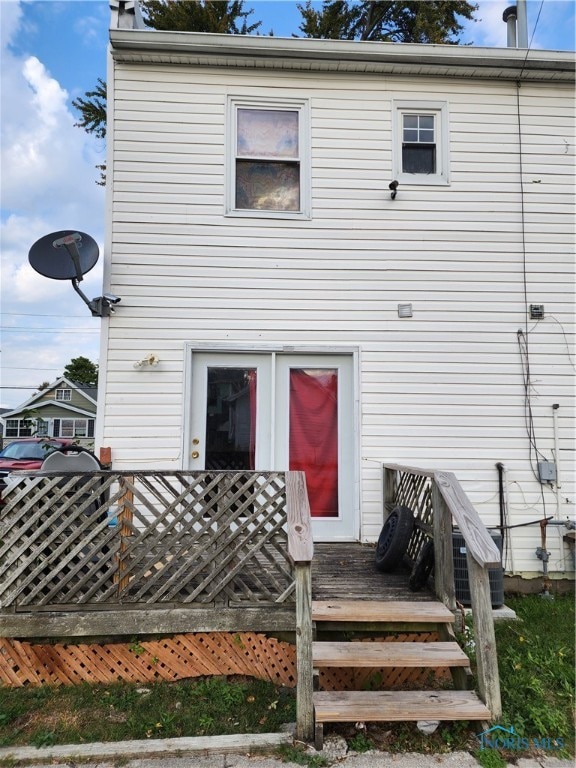 rear view of property featuring a deck