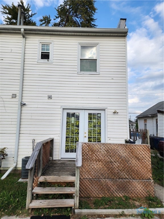 back of property featuring central AC unit