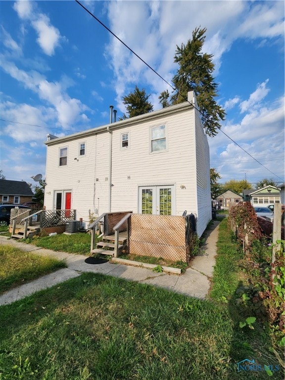 rear view of property with central AC unit