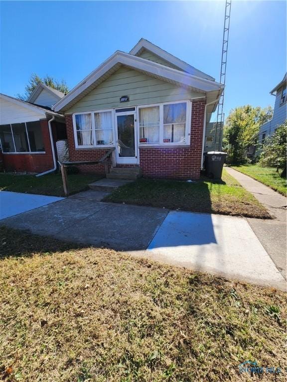 bungalow-style house featuring a front yard