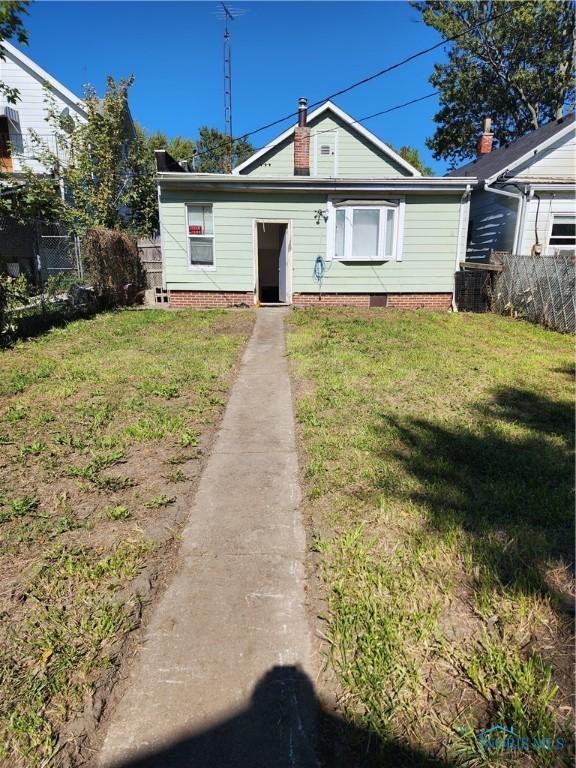 bungalow-style house featuring a front yard