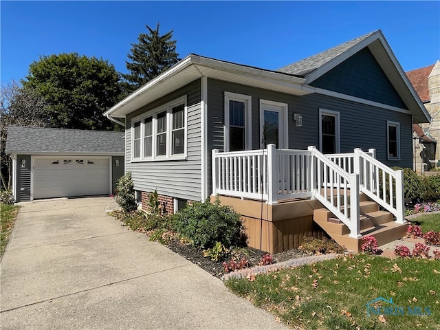 view of front of home with a garage and an outdoor structure