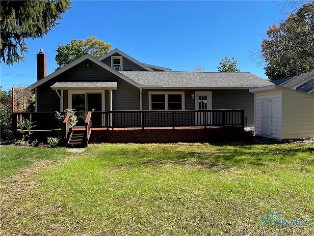 view of front of property featuring a front yard and a wooden deck