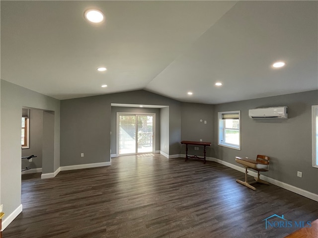 interior space with plenty of natural light, dark hardwood / wood-style floors, and a wall mounted AC