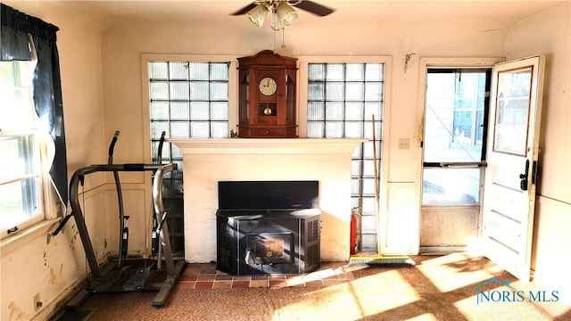 living room with ceiling fan and a healthy amount of sunlight