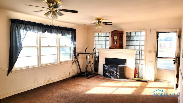 living room featuring ceiling fan and carpet