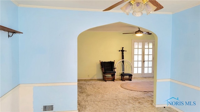 sitting room featuring carpet floors, crown molding, and ceiling fan