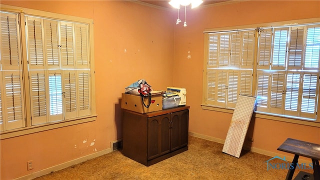 carpeted office with ornamental molding and ceiling fan