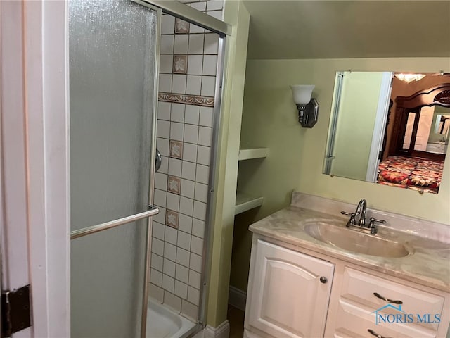 bathroom featuring walk in shower and vanity