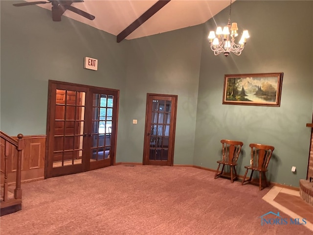 entrance foyer with ceiling fan with notable chandelier, high vaulted ceiling, carpet floors, and french doors