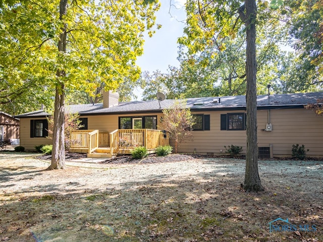 back of house featuring a deck