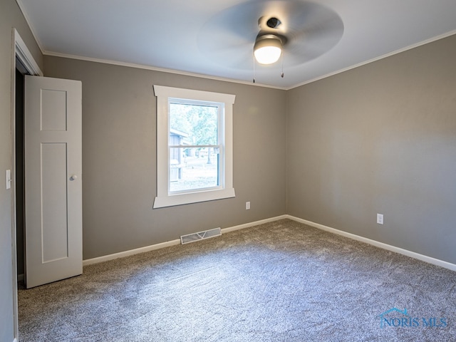 carpeted empty room with ceiling fan and crown molding