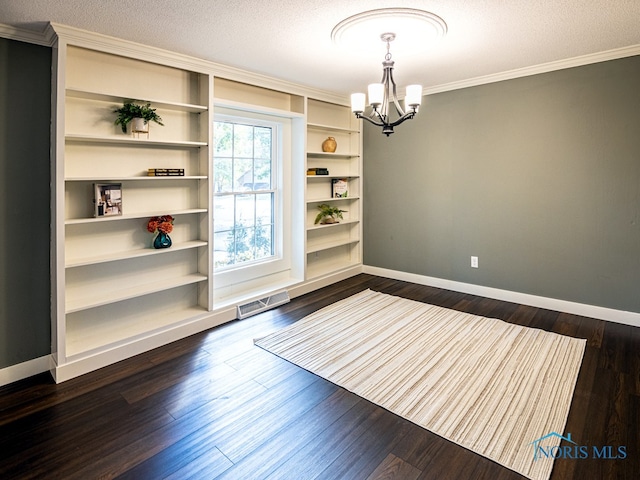 unfurnished dining area with crown molding, a chandelier, dark hardwood / wood-style flooring, and a textured ceiling