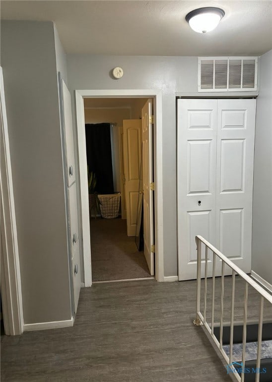 corridor featuring dark wood-type flooring