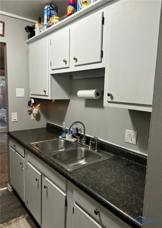 kitchen featuring sink, dark hardwood / wood-style floors, and white cabinets