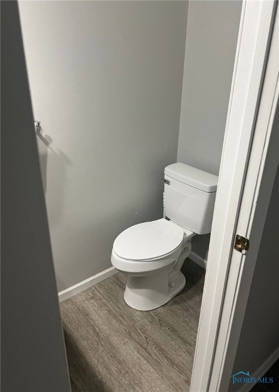 bathroom with hardwood / wood-style floors and toilet