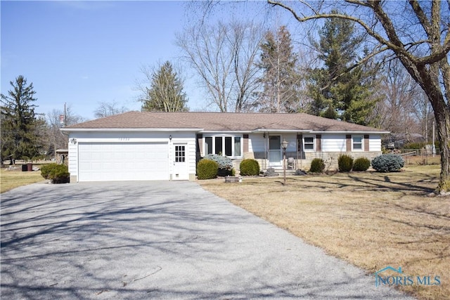 single story home featuring driveway, stone siding, and an attached garage