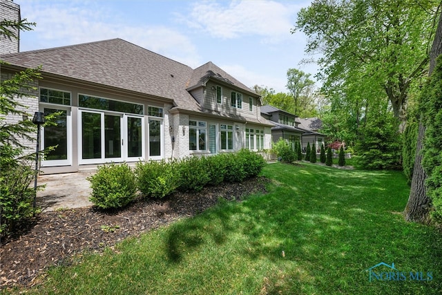 rear view of house with a yard