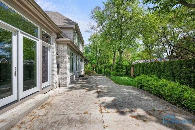 view of property exterior featuring a patio area