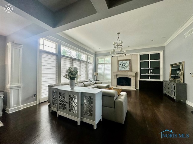 living room with ornamental molding, a notable chandelier, and dark hardwood / wood-style flooring