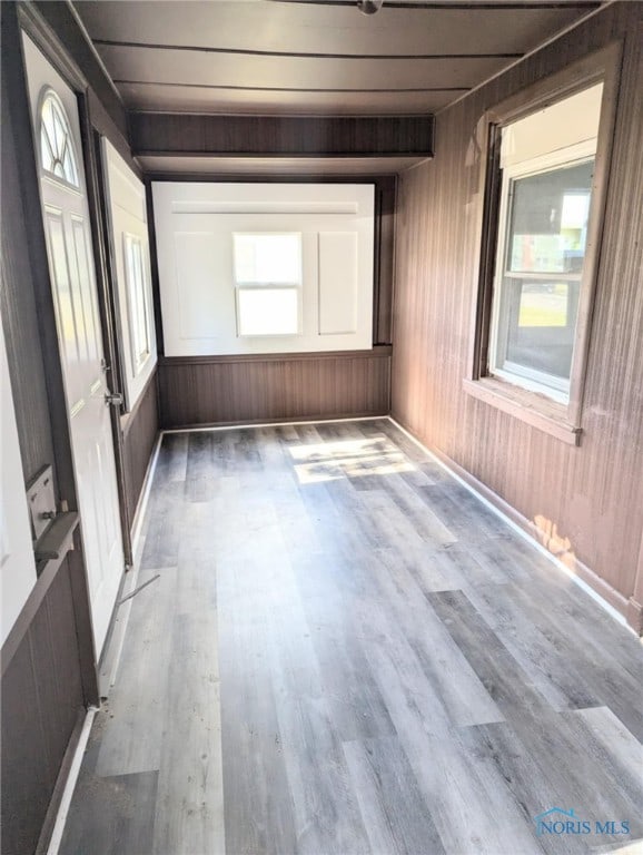 spare room with wood walls and hardwood / wood-style floors