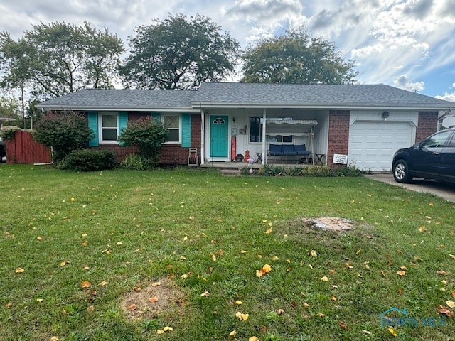 single story home with a garage and a front lawn