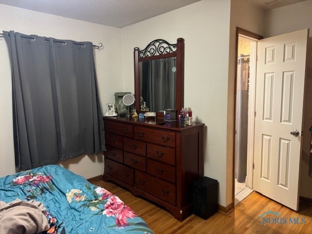 bedroom featuring wood-type flooring