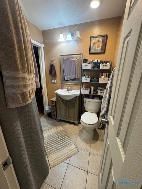 bathroom featuring tile patterned floors, toilet, and vanity