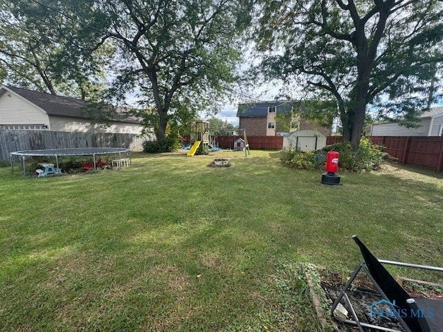 view of yard featuring a playground and a storage shed