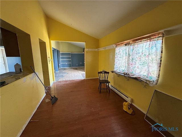 corridor featuring a baseboard radiator, vaulted ceiling, and hardwood / wood-style flooring