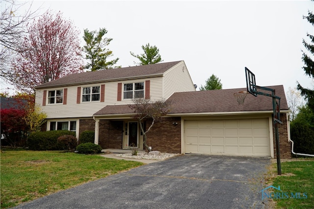 front of property with a front yard and a garage