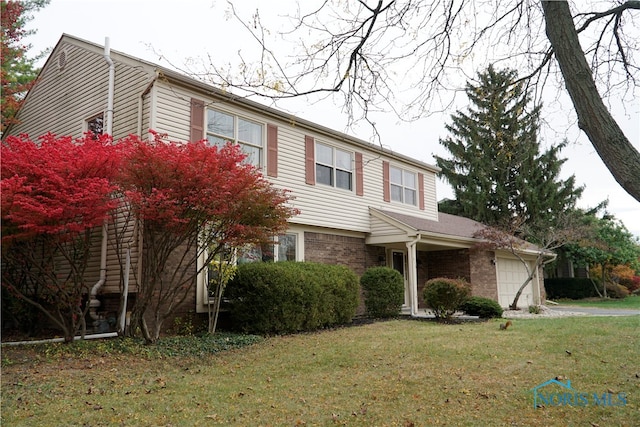 view of property with a front yard and a garage