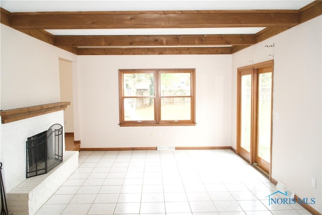 unfurnished living room featuring light tile patterned flooring, beamed ceiling, and a brick fireplace