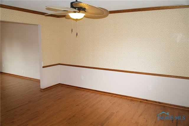 unfurnished room with crown molding, wood-type flooring, and ceiling fan