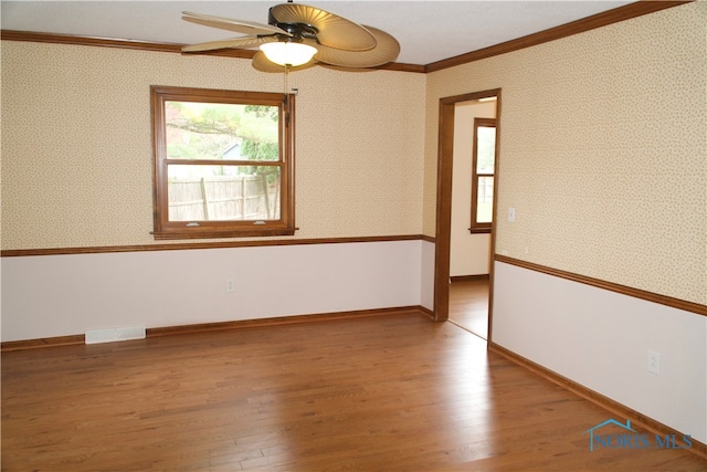 unfurnished room with ceiling fan, ornamental molding, and light hardwood / wood-style flooring