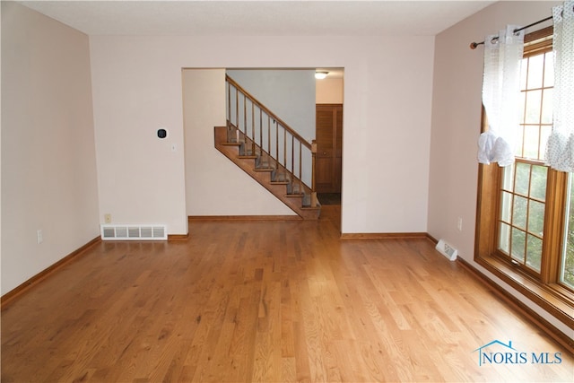 unfurnished room featuring light hardwood / wood-style flooring