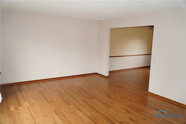 empty room featuring wood-type flooring