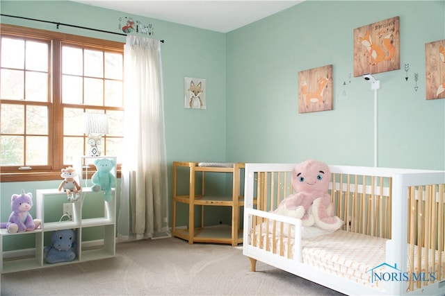 carpeted bedroom featuring a nursery area and multiple windows